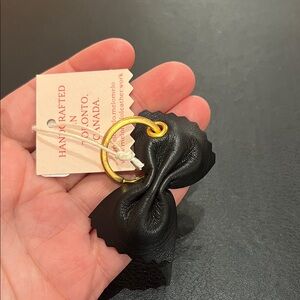 Elegant Black Leather Bow Keychain with Gold Accent